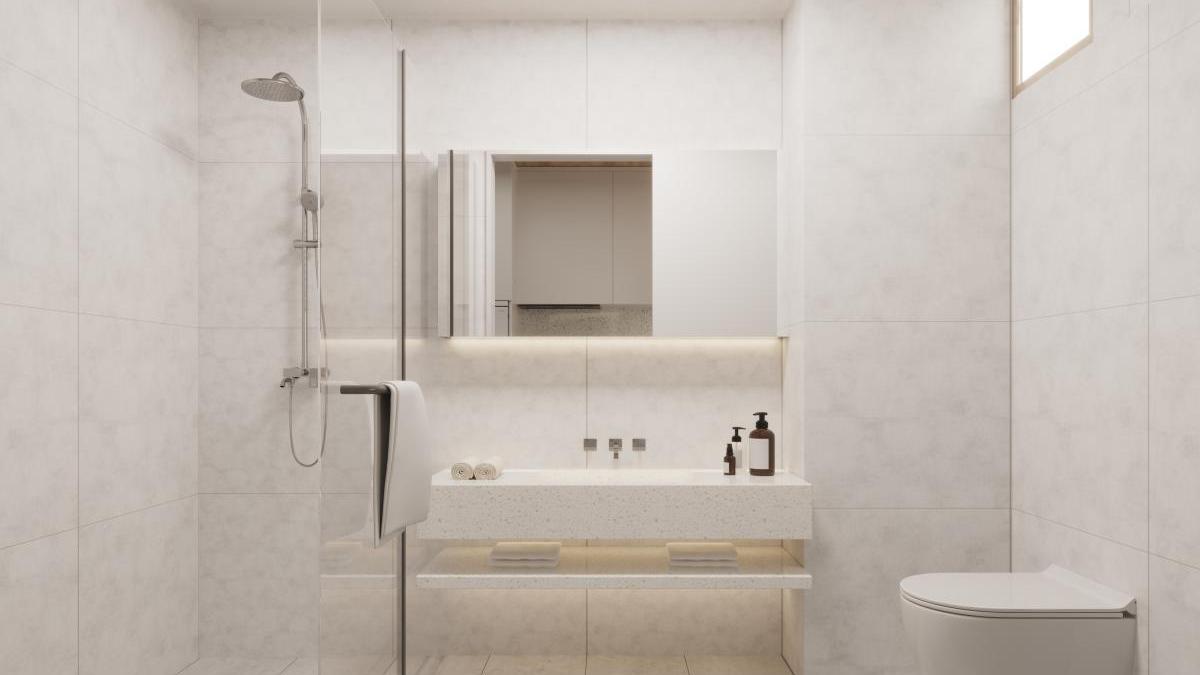 bathroom of studio apartment with a shower, a toilet, a window